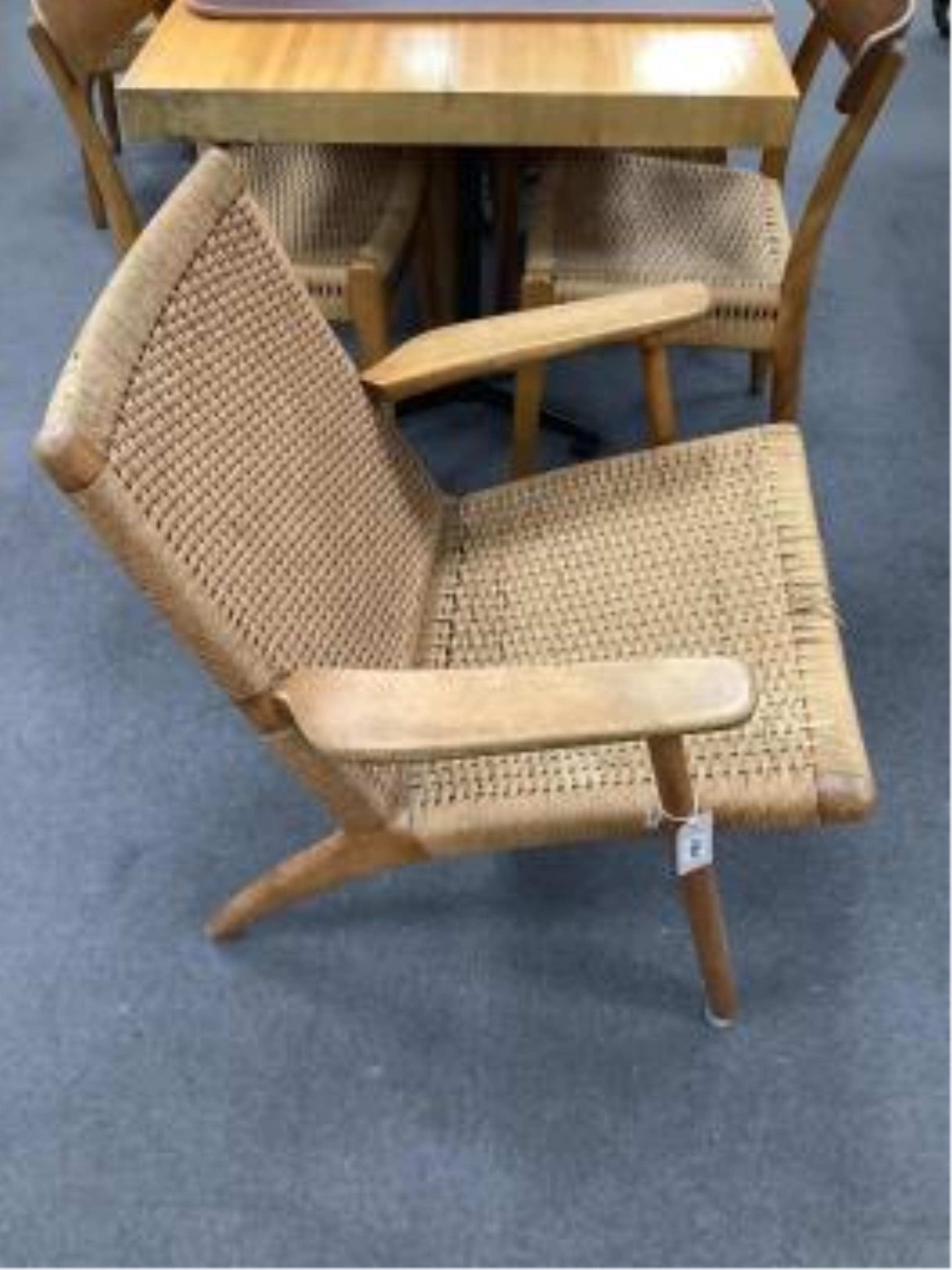 Hans J Wegner for Carl Hansen & Son, a model CH25 oak beech and paper cord lounge chair, width 70cm, depth 70cm, height 74cm. Condition - fair